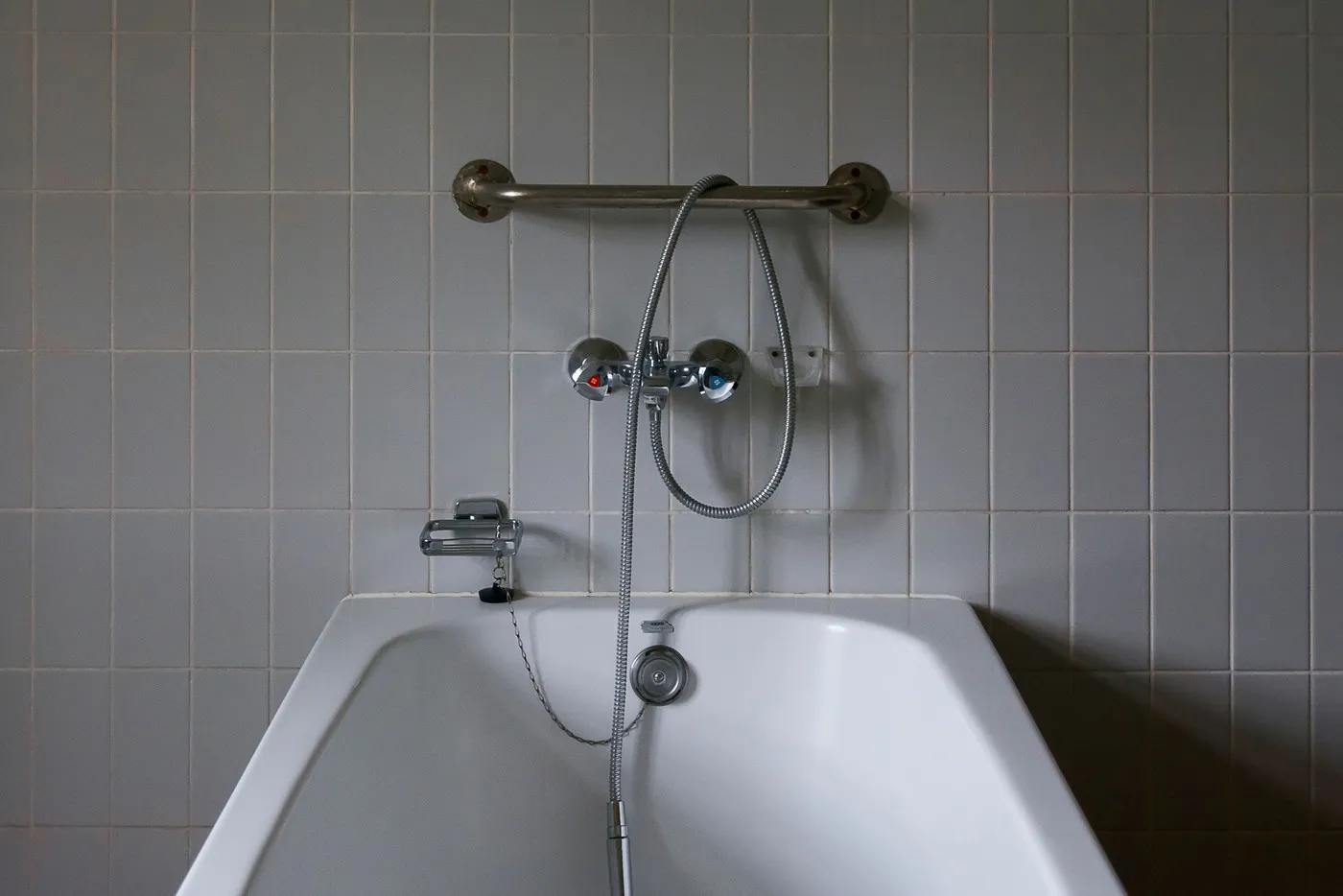 Baignoire équipée d'une barre d'appui et d'une douchette, à remplacer par une douche (Cassis, Bouches-du-Rhône)
